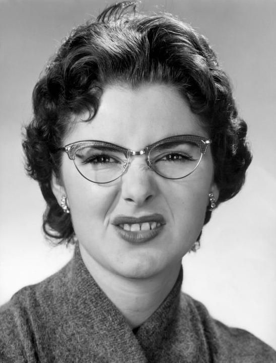 a black and white photo of a woman wearing glasses with the words smile on it