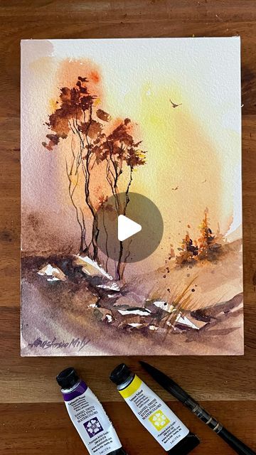 painting with watercolors on a wooden table