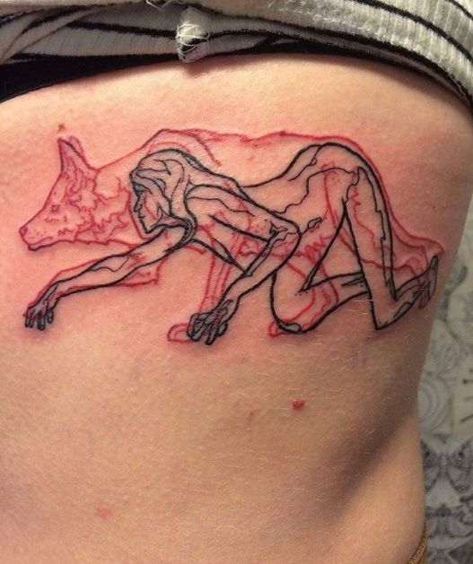 a woman's thigh with a drawing of a dog on the side and red ink