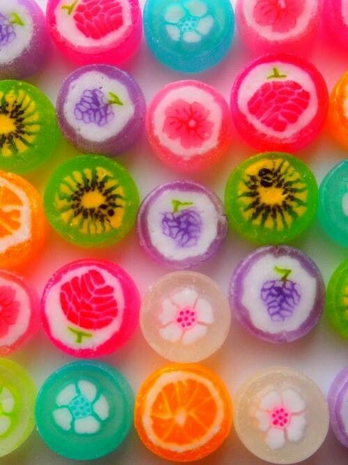 colorful candies are arranged in the shape of fruit