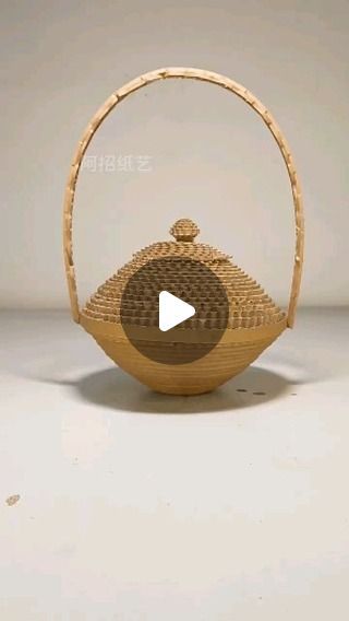 a bamboo basket with a wooden handle is shown in front of a white background and the video appears to be made by hand