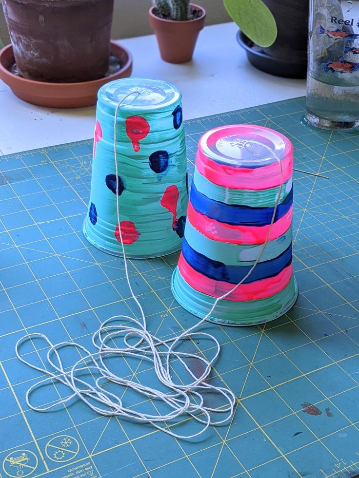 there are two cups on the table next to each other with wires in front of them