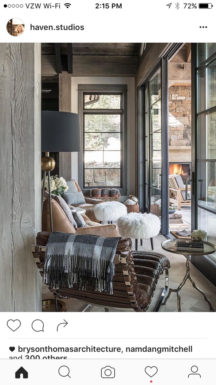 a living room filled with lots of furniture next to large glass windows on the wall