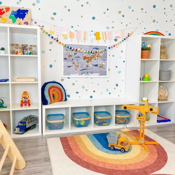 a child's playroom with toys and bookshelves