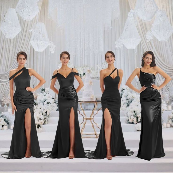 four women in long black dresses posing for the camera with one woman standing behind them