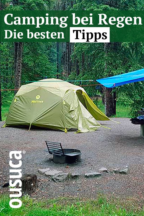 there is a tent and picnic table in the woods next to a camper's tent