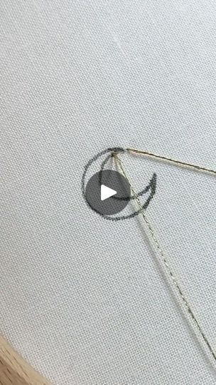 a video demonstrating how to use the sewing needle on an upholstered piece of fabric