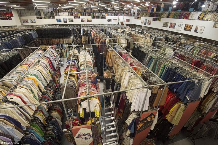 a rack full of shirts and pants in a store