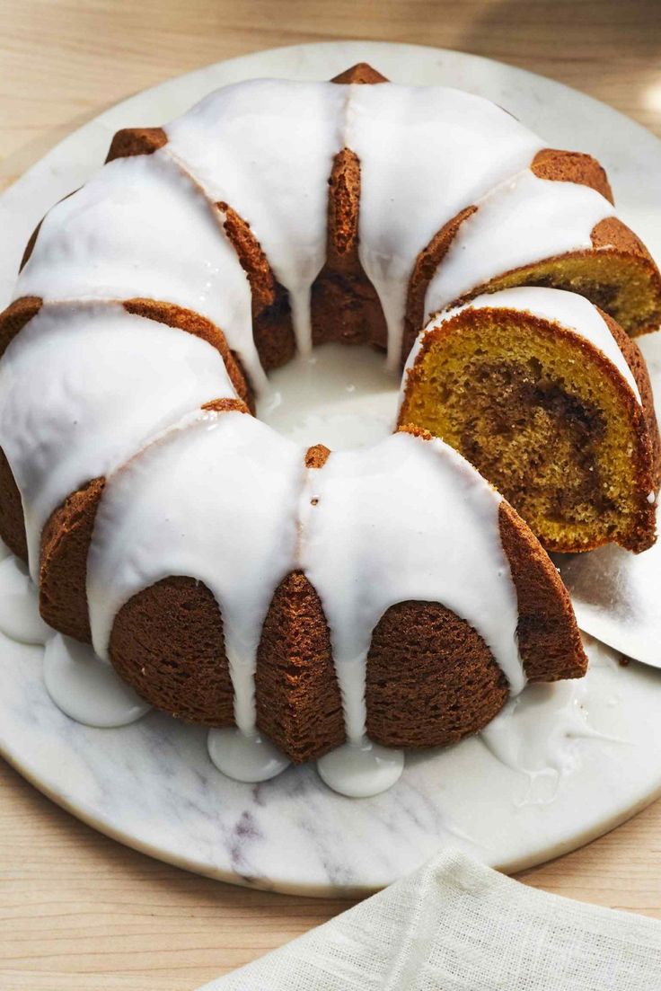 a bundt cake with white icing on a plate