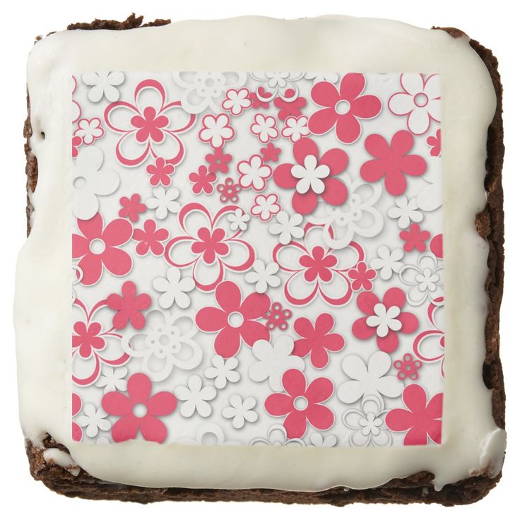 a cake with white frosting and pink flowers on it