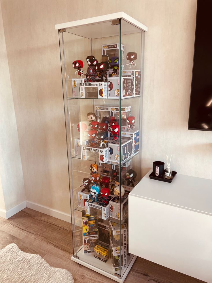 a tall glass display case filled with lots of items