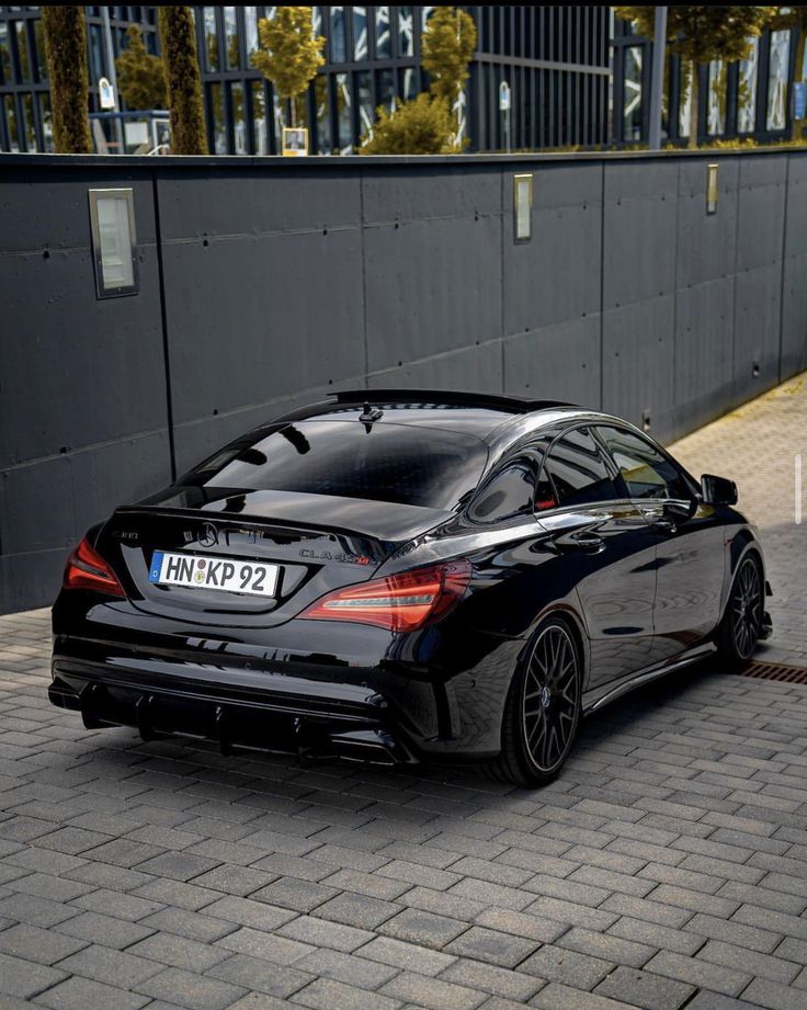 a black car is parked on the street