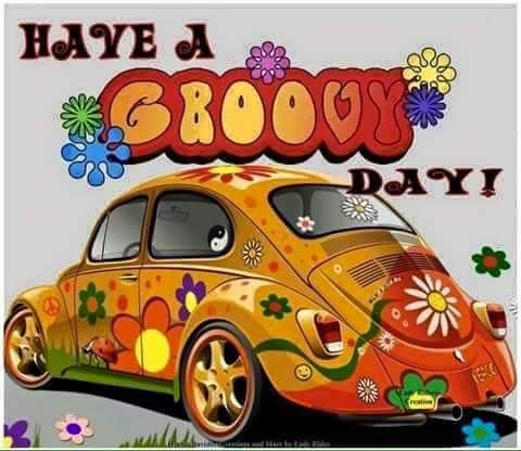 an orange car with flowers and the words have a grooy day