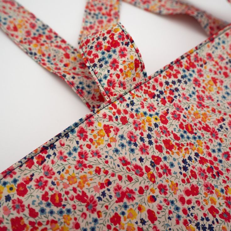 a colorful floral print neck tie on a white surface