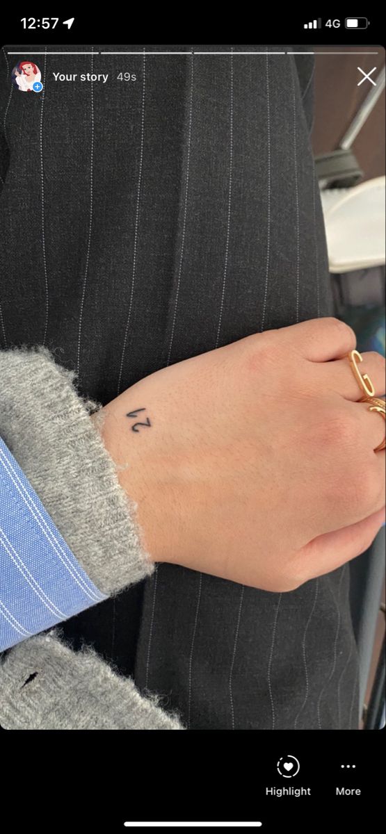 a person wearing a suit and tie with a gold ring on their left hand,