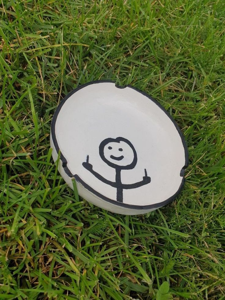 a white frisbee with a black and white drawing of a person on it