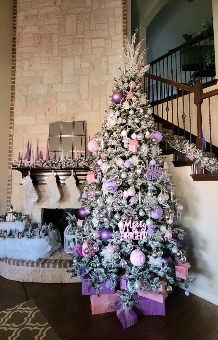 a decorated christmas tree sitting in front of a fireplace