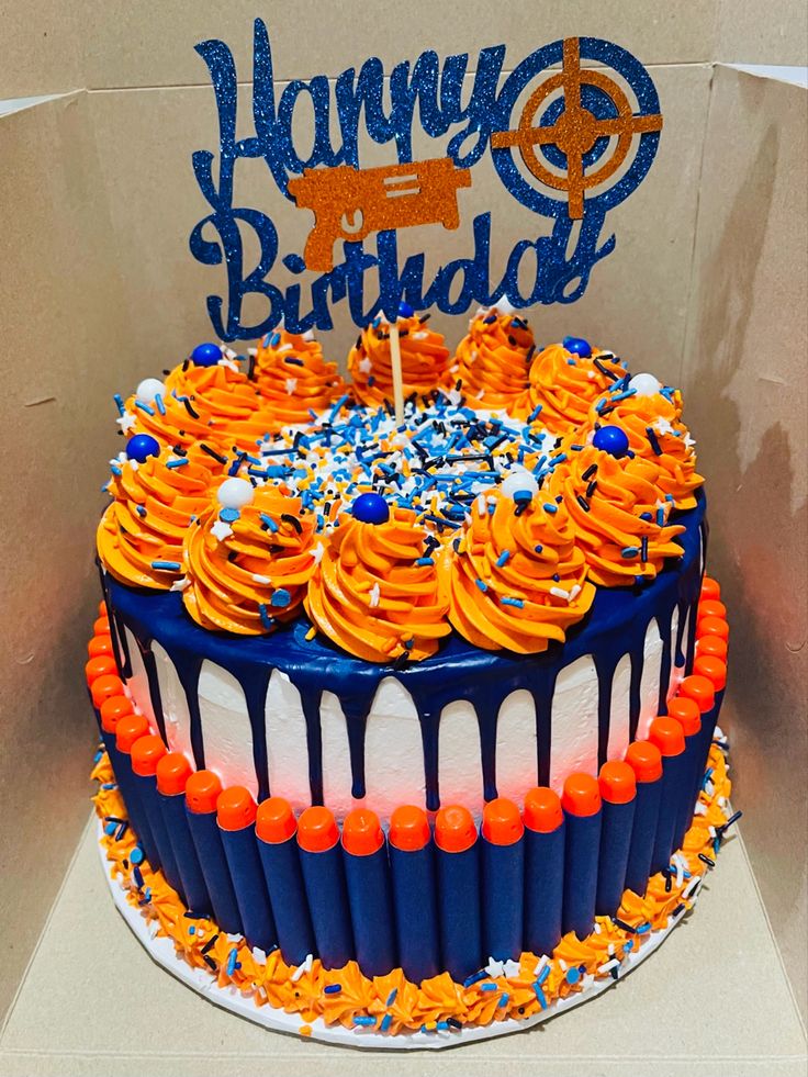 a birthday cake with orange and blue frosting