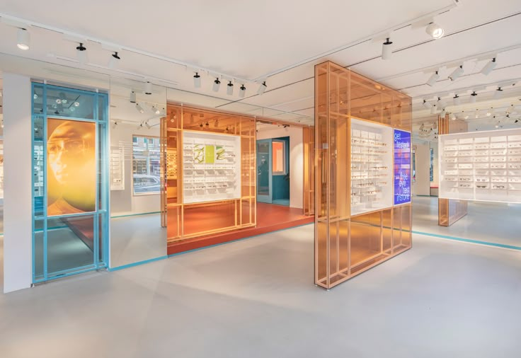 an empty room with many different colored glass cases on the walls and in the floor