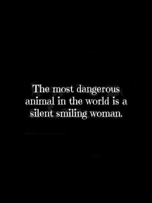 the most dangerous animal in the world is a silent smiling woman quote on black background