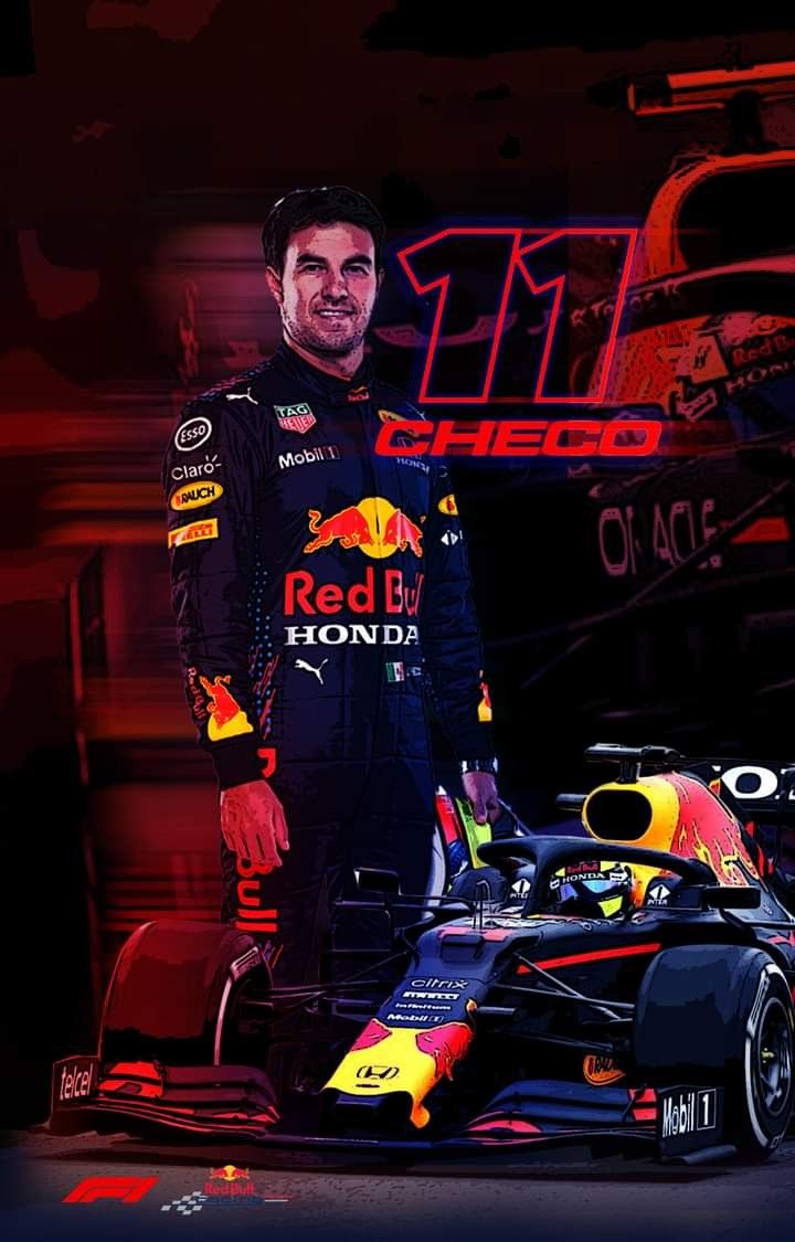 a man standing next to a red bull racing car