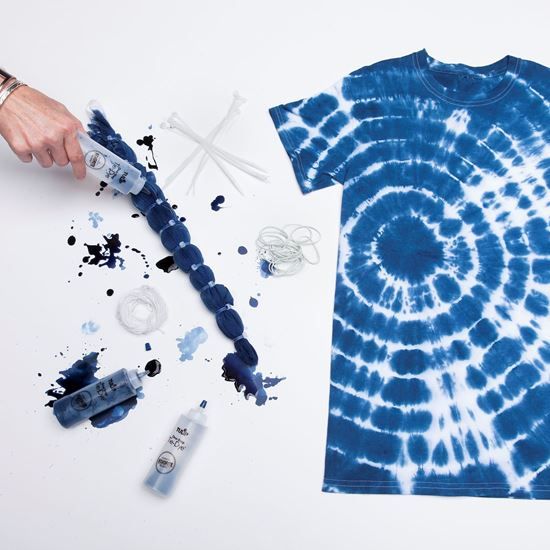 a tie - dyed t - shirt is being made with glue and other crafting supplies