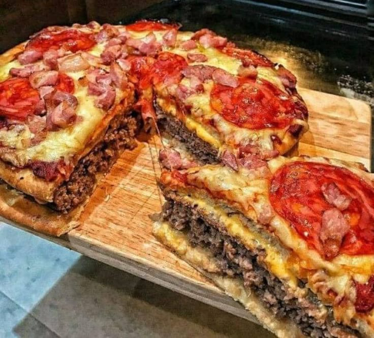 there is a large pizza with many toppings on the top and one slice missing