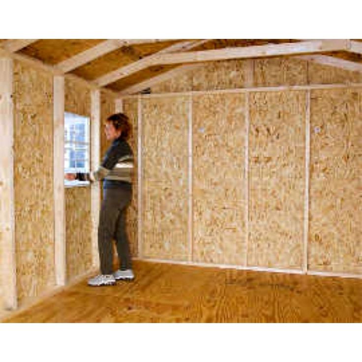 a woman standing in the corner of a room that is being built