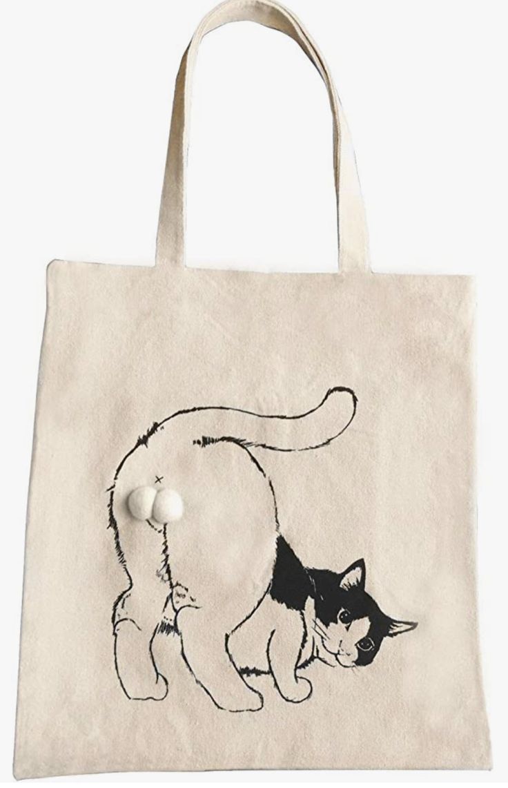 a white tote bag with a black and white cat design on it's side