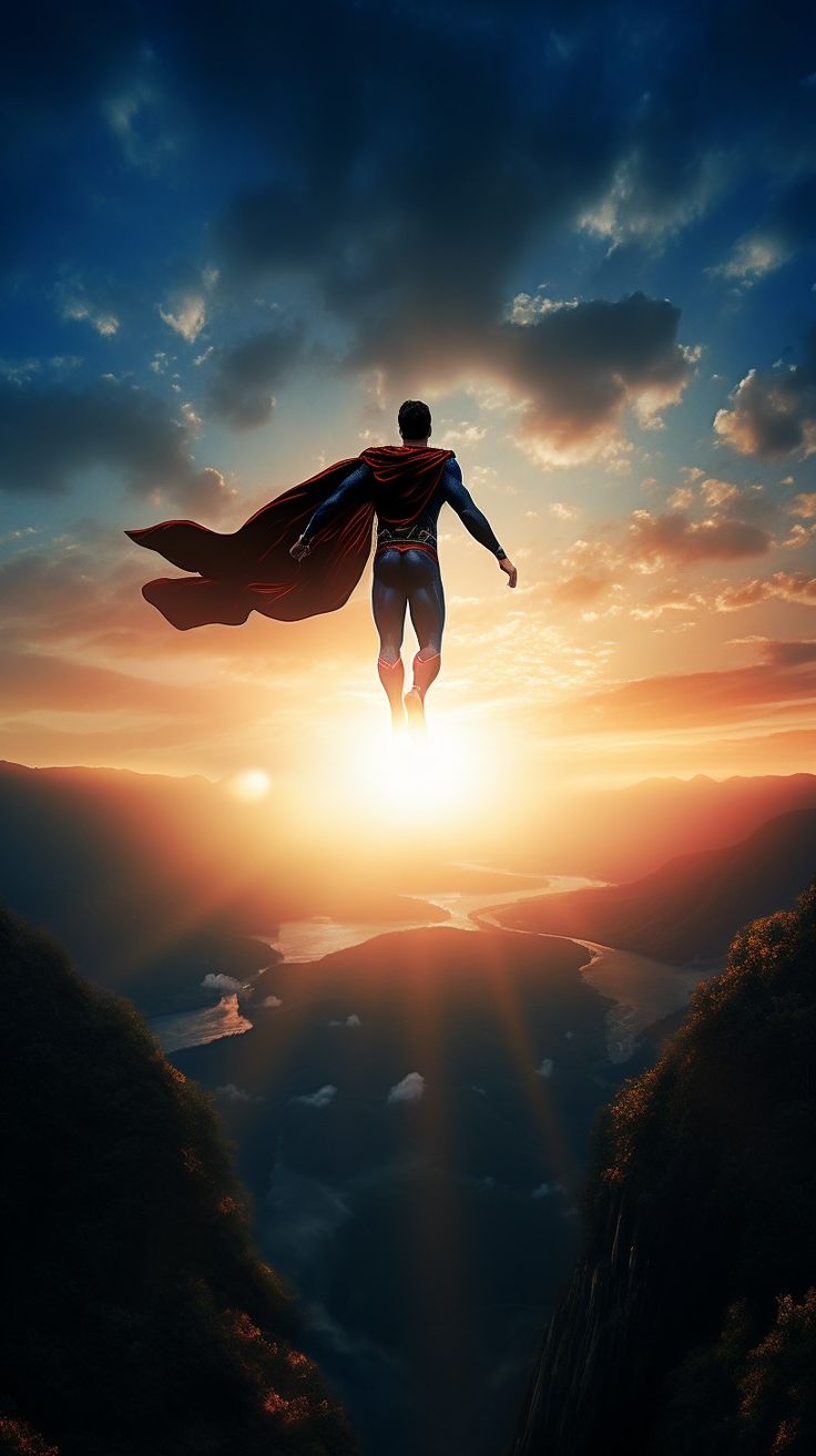 a man flying through the air while wearing a superman suit on top of a mountain