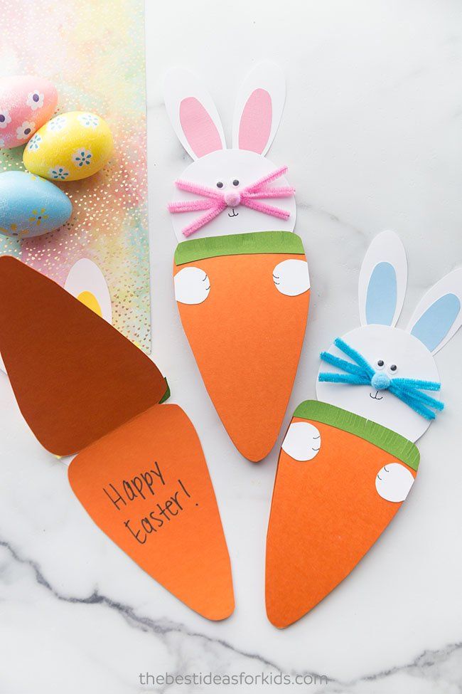 three paper carrots with bunny ears on them