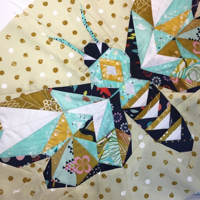 a close up view of a piece of fabric with gold and white polka dots on it