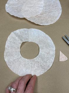 someone is making some paper circles with scissors