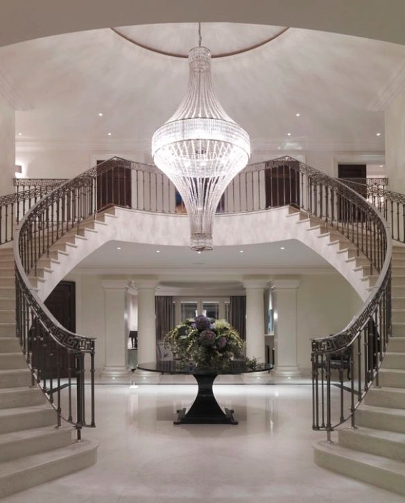 a large foyer with chandelier and stairs