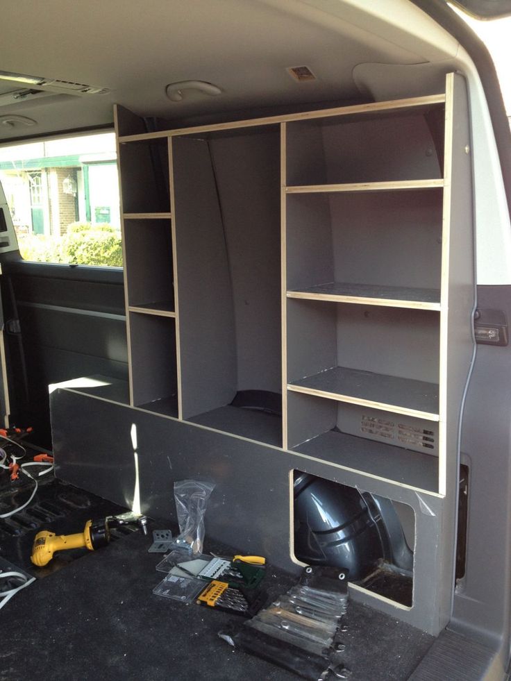 the inside of a van with shelves and tools