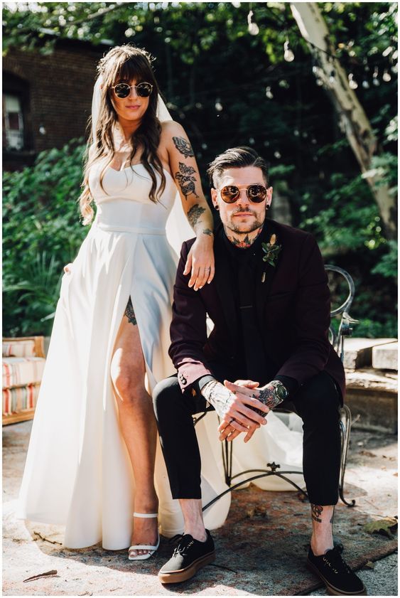 a man sitting next to a woman in a white dress