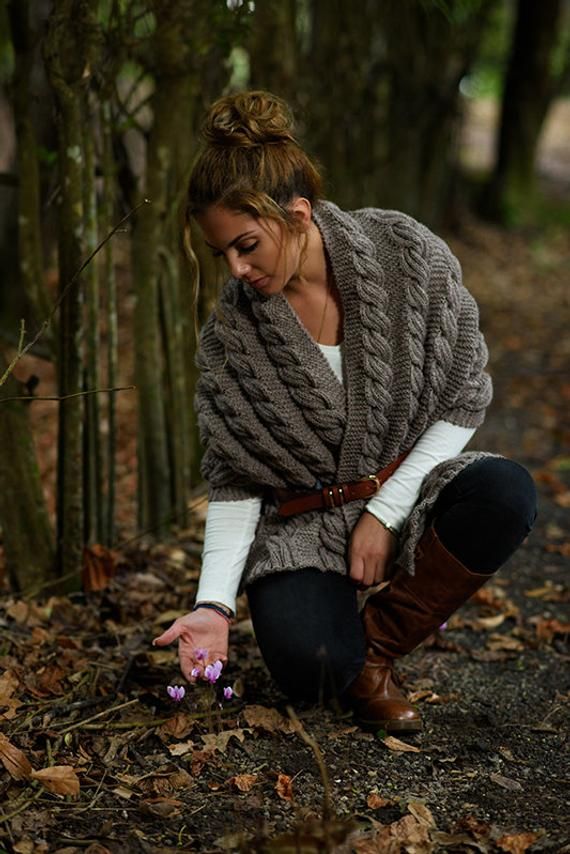 a woman kneeling down in the woods with her hands together and text overlay that reads free knitting pattern cable shawl