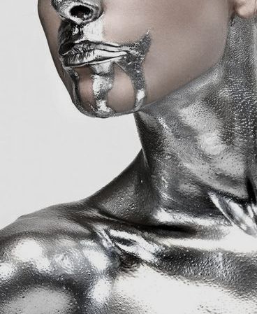 a woman with silver paint on her face