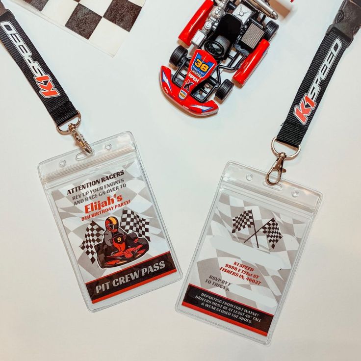 two lanyard tags with race cars on them, one is red and the other is white