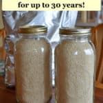 two jars filled with sand sitting on top of a table