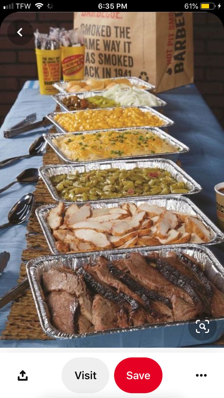 several trays of food are lined up on a table