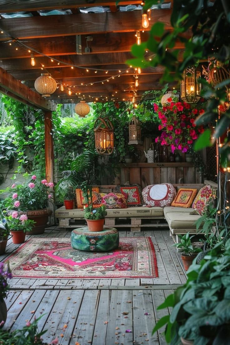 an outdoor patio with lots of plants and lights