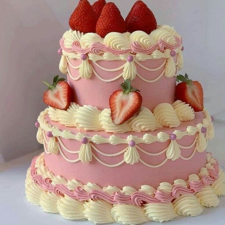 a three tiered cake with strawberries on top