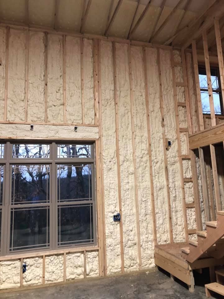 the inside of a house being built with wood framing and windows on each side of the wall