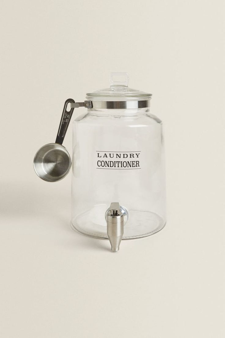 a glass jar with a spoon in it and a label on the lid that says laundry conditioner