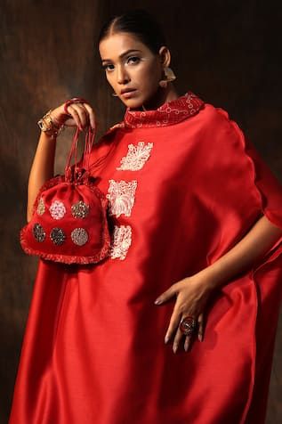 Crimson red kaftan with embroidered motifs and bandhani print collar. Paired with a bandhani print pant. Comes along with an inner.
Components: 3
Pattern: Embroidery
Type Of Work: Motif
Neckline: Collared Neck
Sleeve Type: Three Quarter Sleeves
Fabric: Chanderi
Color: Red
Other Details: 
Length:
Kaftan: 38 inches
Pant: 37 inches
Model height: 5ft 6inches, wearing size M
Weight: 300 gms
Note: The potli bag shown in the image is not for sale
Disclaimer: Sustainable clothes designed with organic fa Red Kaftan With Dupatta For Festivals, Festive Red Kaftan With Dupatta, Red Silk Bollywood Kaftan, Designer Red Kurta With Embroidered Border, Red Designer Kaftan For Navratri, Designer Red Kaftan For Navratri, Elegant Red Designer Wear Kaftan, Elegant Red Designer Kaftan, Red Kaftan With Zari Work For Festivals