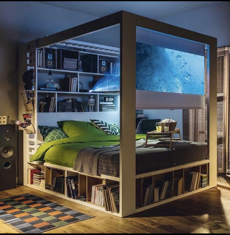 there is a bed that has been built into the wall with bookshelves on it