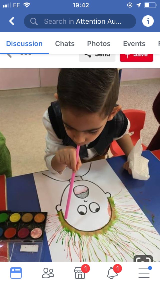 a young boy is painting with colored pencils