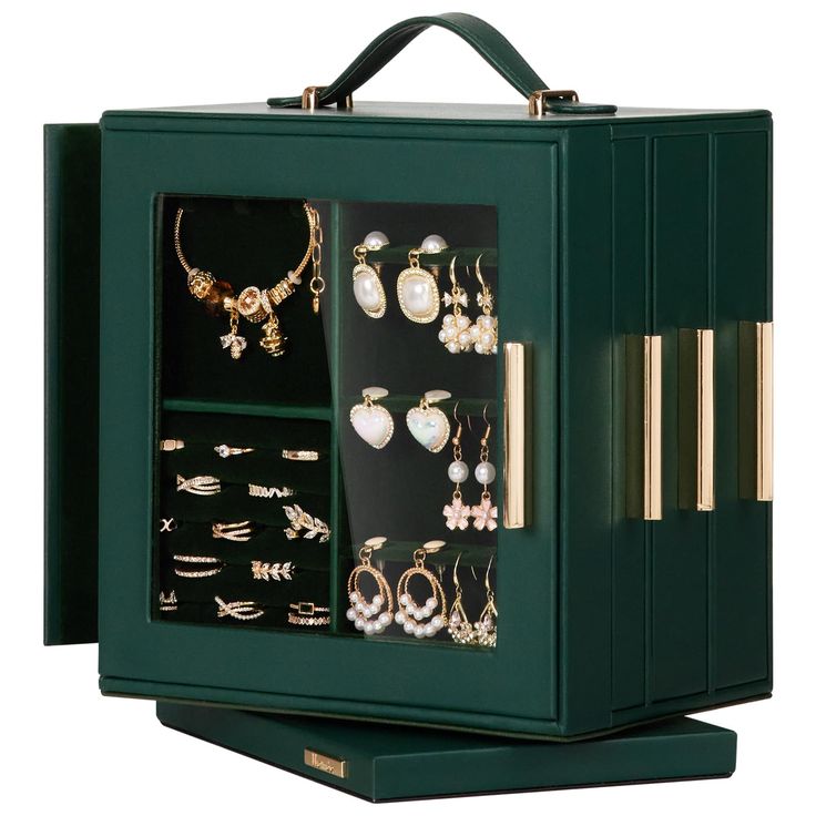 a green box with many different types of jewelry in it's display case on a white background