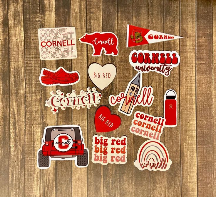 various stickers are arranged on a wooden surface